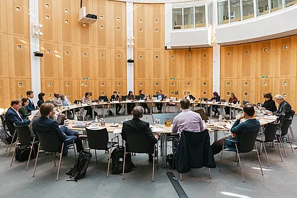 photos of participants sitting around a table