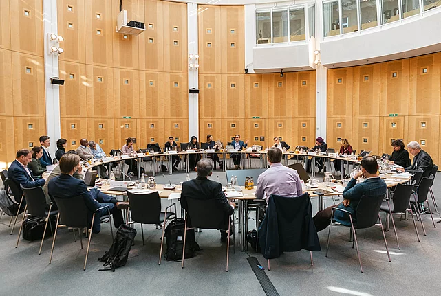 photos of participants sitting around a table