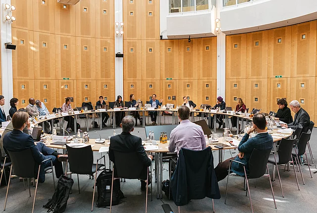 photos of participants sitting around a table